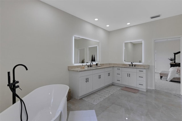 bathroom with a bath and vanity