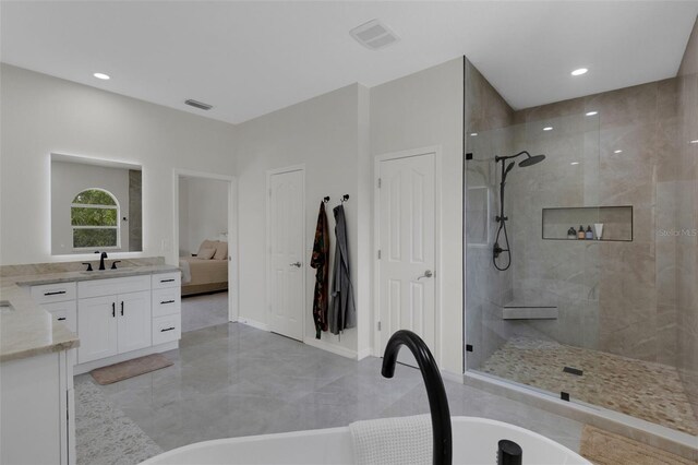 bathroom featuring vanity and shower with separate bathtub