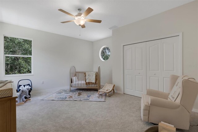 living area featuring light carpet and ceiling fan