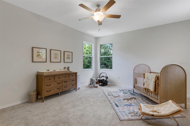 living area featuring ceiling fan and light colored carpet