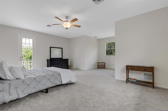 bedroom featuring light colored carpet, access to outside, and ceiling fan