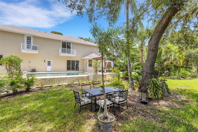 view of yard with a patio area and a balcony