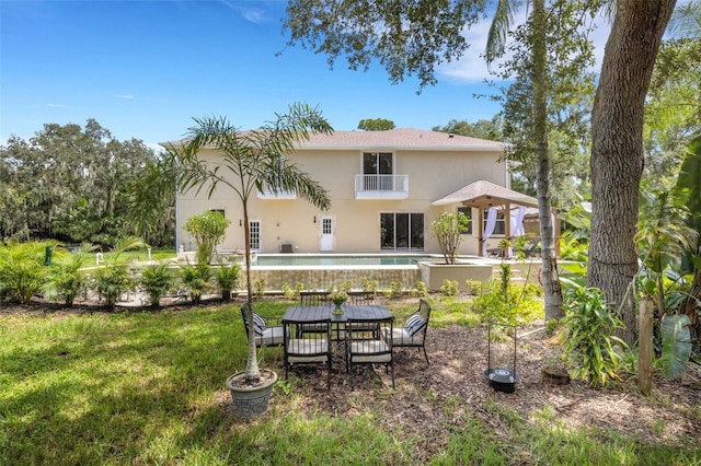 back of house with a yard and a patio