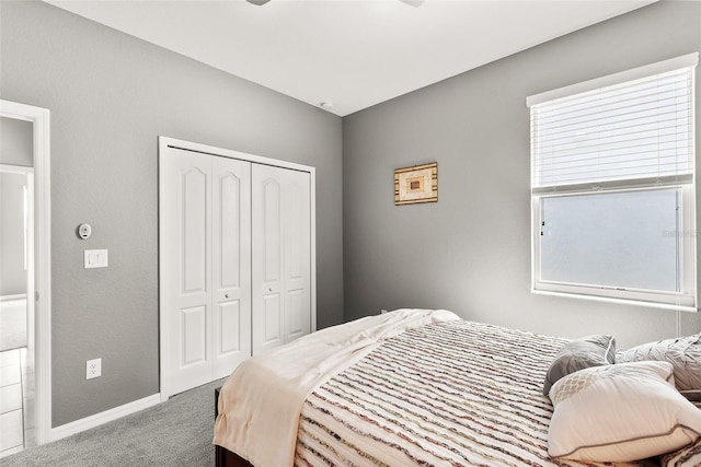 bedroom with multiple windows, a closet, and carpet flooring