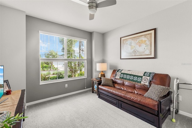 living room with ceiling fan and carpet flooring