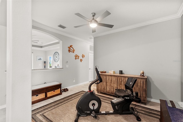 exercise area with light wood-type flooring, ceiling fan, and ornamental molding