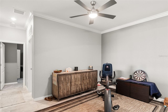 exercise area featuring ceiling fan and ornamental molding