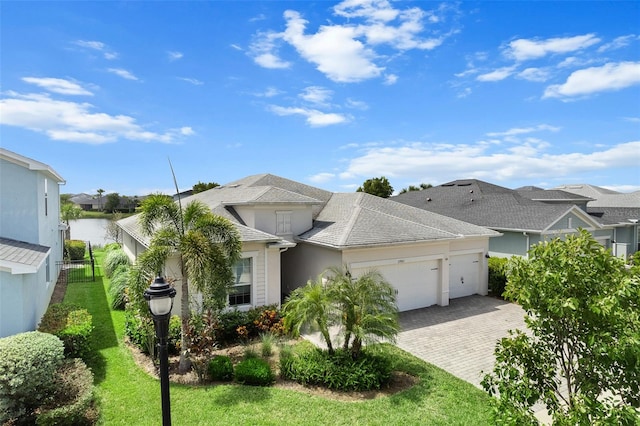 view of front facade with a front lawn and a garage