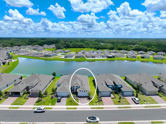 drone / aerial view featuring a residential view and a water view