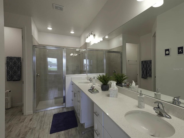 bathroom with vanity, hardwood / wood-style floors, and an enclosed shower