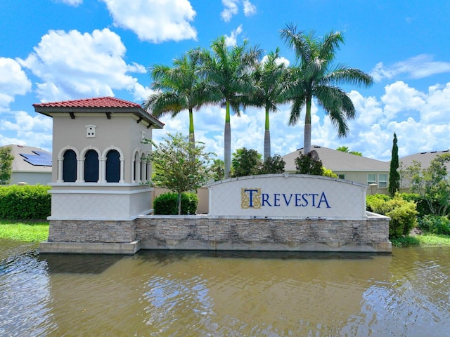 community sign featuring a water view