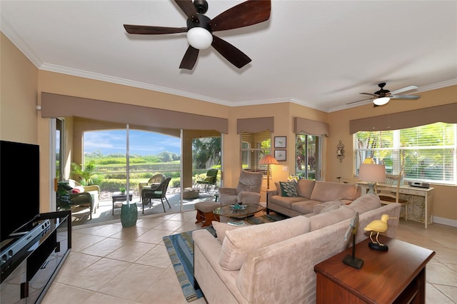 living room with ceiling fan, plenty of natural light, light tile patterned flooring, and ornamental molding