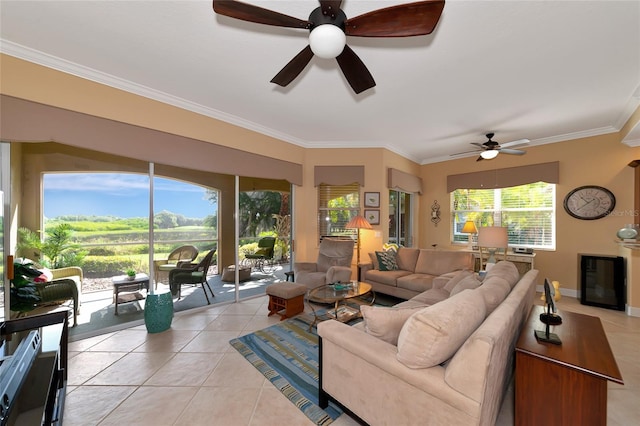 tiled living room with ceiling fan and crown molding