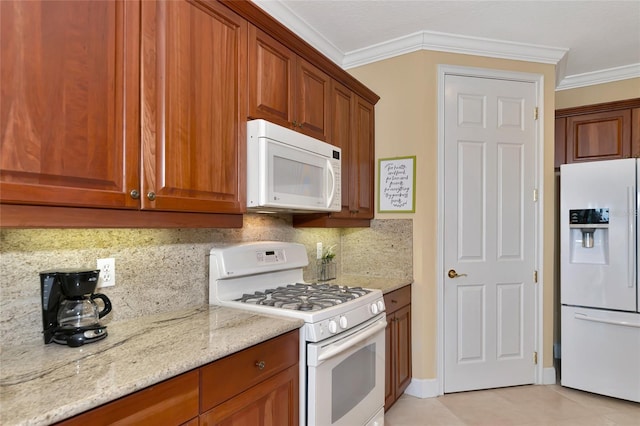 kitchen featuring light stone countertops, white appliances, light tile patterned floors, crown molding, and decorative backsplash