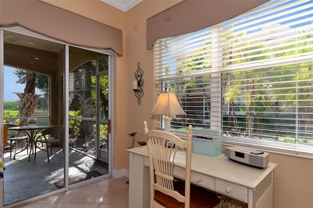 interior space with a healthy amount of sunlight, ornamental molding, and light tile patterned floors