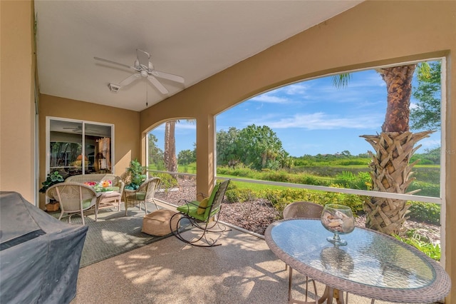 sunroom featuring ceiling fan