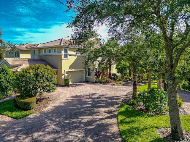 mediterranean / spanish-style home featuring a garage