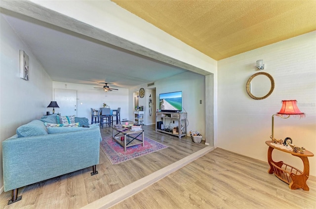 living room featuring hardwood / wood-style flooring and ceiling fan