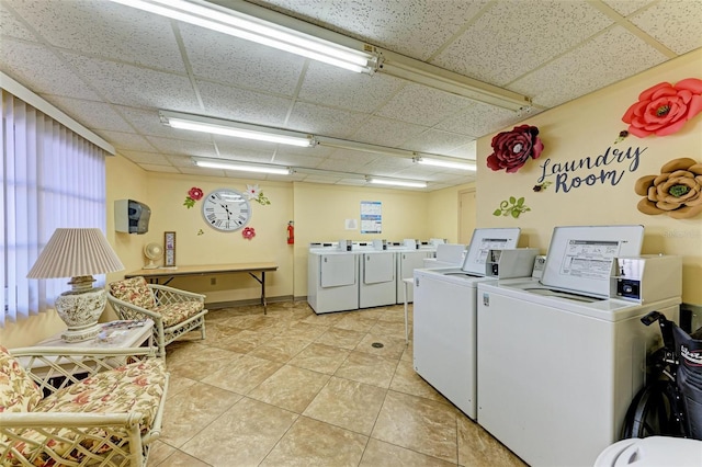 laundry area with light tile patterned flooring and washing machine and clothes dryer