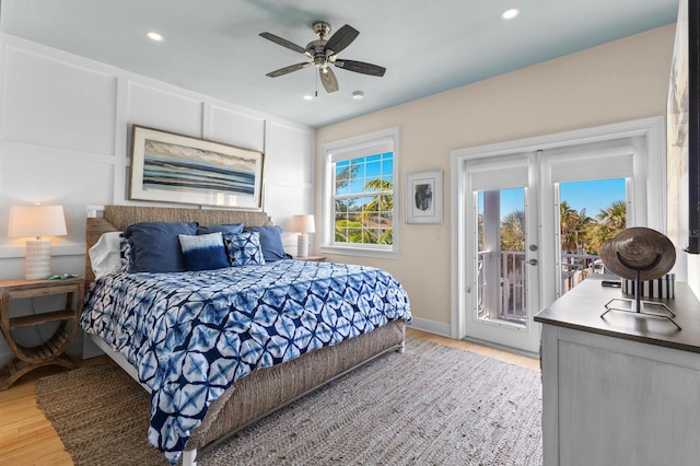 bedroom featuring multiple windows, ceiling fan, light hardwood / wood-style flooring, and access to exterior