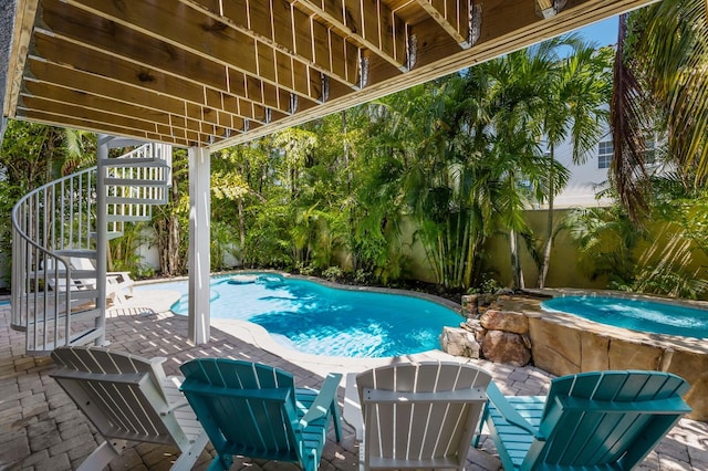 view of pool with an in ground hot tub and a patio area