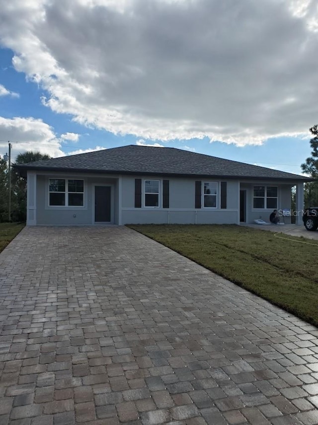 ranch-style house featuring a front yard and a carport