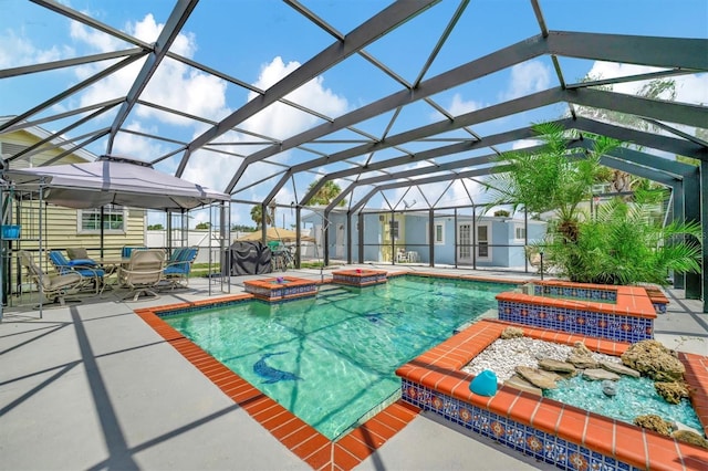 view of pool with a lanai, a patio, and an in ground hot tub