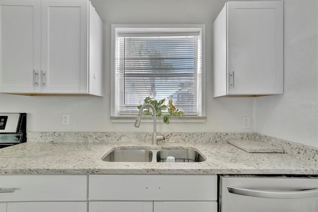 kitchen featuring light stone countertops, dishwasher, white cabinetry, and a sink