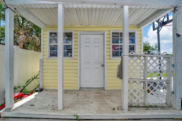 view of exterior entry with a deck