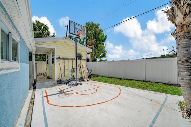 view of patio / terrace featuring fence and basketball court