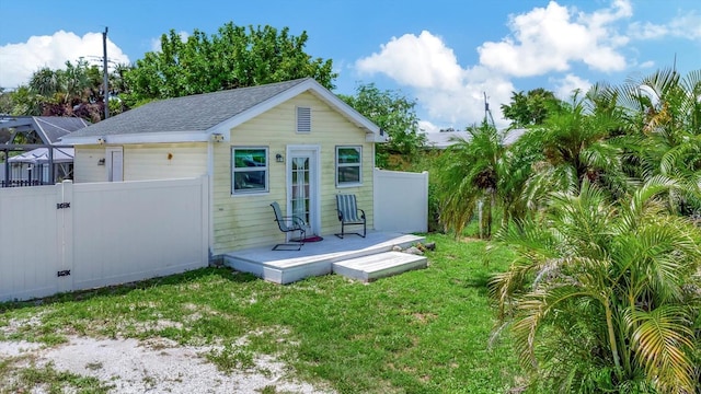 view of outbuilding with a garage and fence