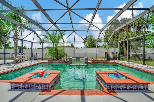 view of swimming pool with a lanai, a patio, a pool with connected hot tub, and a fenced backyard