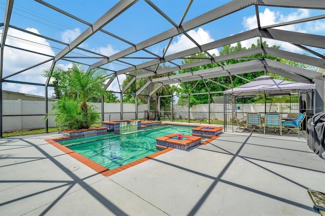 view of swimming pool featuring a fenced in pool, glass enclosure, a fenced backyard, a jacuzzi, and a patio