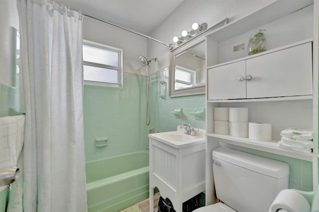 full bathroom featuring vanity, toilet, and shower / tub combo with curtain