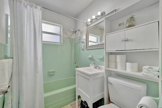 full bathroom featuring toilet, plenty of natural light, vanity, and shower / tub combo with curtain