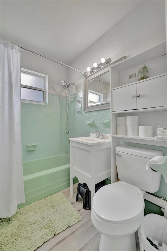 full bathroom with vanity, toilet, hardwood / wood-style floors, and shower / bath combo