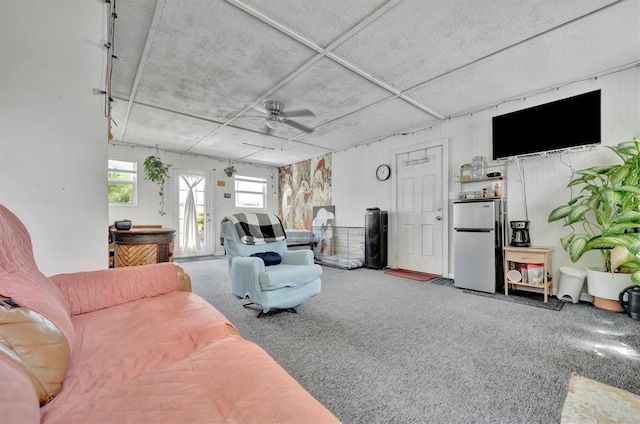 living room featuring a ceiling fan and carpet floors