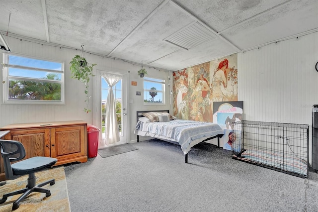 bedroom with access to exterior and carpet floors