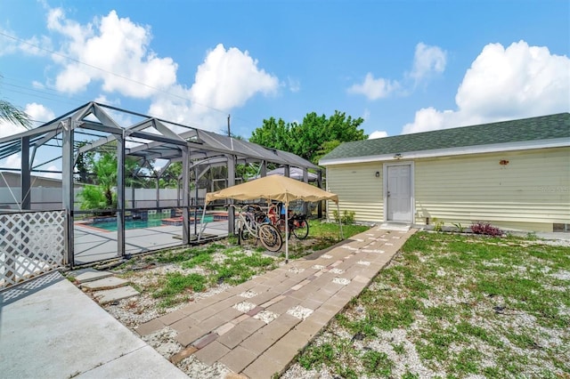 view of yard featuring a fenced in pool, a lanai, and a patio area