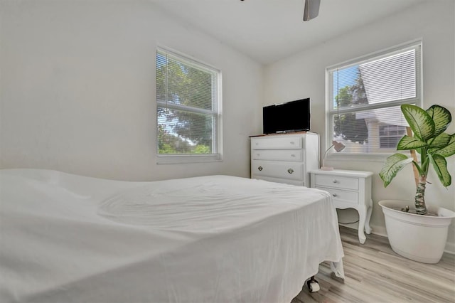 bedroom with a ceiling fan and light wood finished floors