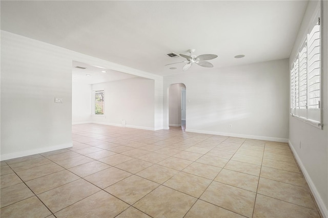 tiled spare room featuring ceiling fan