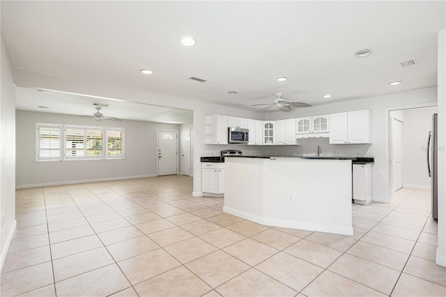 kitchen featuring white cabinets, appliances with stainless steel finishes, light tile patterned flooring, and ceiling fan