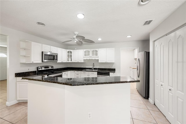 kitchen featuring stainless steel appliances, sink, ceiling fan, and white cabinets