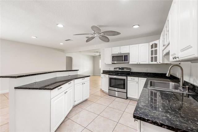 kitchen with white cabinetry, a kitchen island, sink, ceiling fan, and appliances with stainless steel finishes