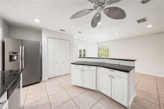 kitchen with stainless steel fridge with ice dispenser, white cabinets, a center island, and ceiling fan