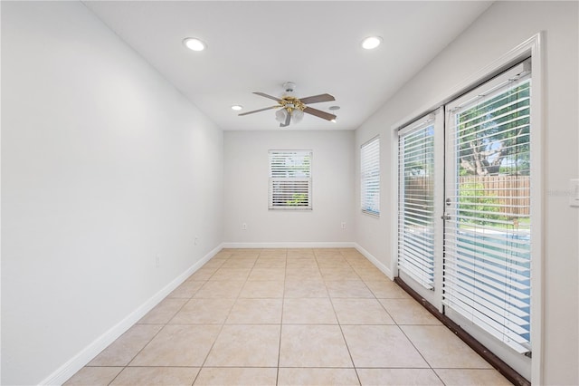 tiled spare room with ceiling fan