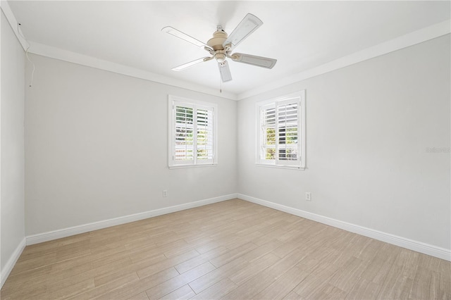 spare room featuring ceiling fan, ornamental molding, and light wood-type flooring