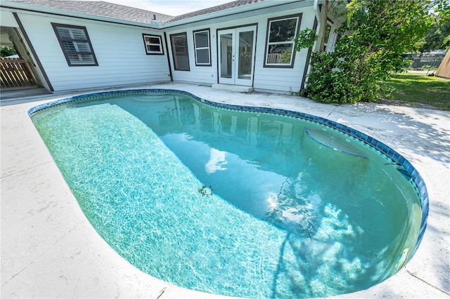 view of pool with french doors