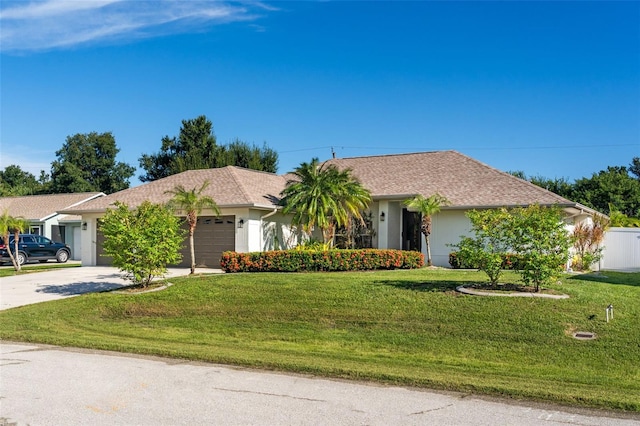 ranch-style house with stucco siding, driveway, a front yard, and a garage