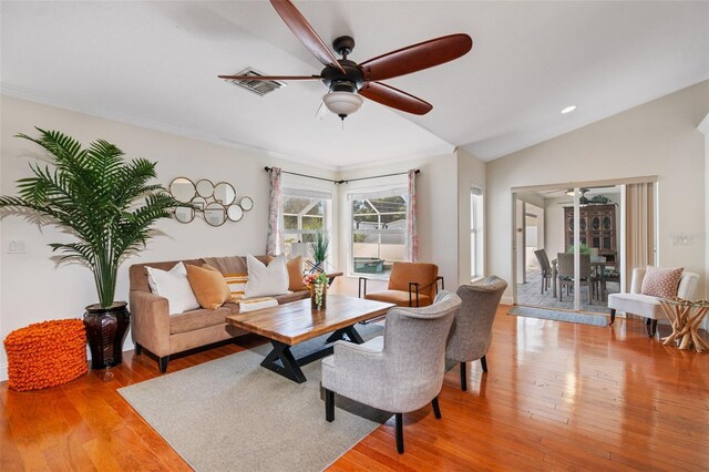 living room featuring vaulted ceiling, wood-type flooring, and ceiling fan